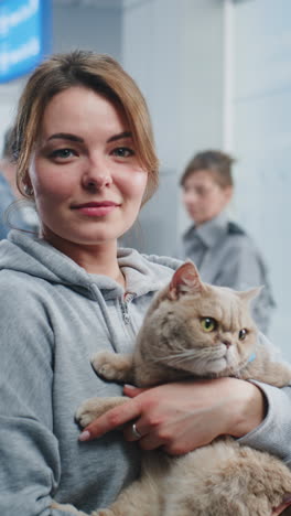 woman holding cat at a vet clinic
