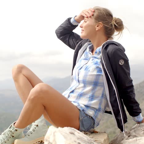 Fit-Woman-Resting-at-Rock