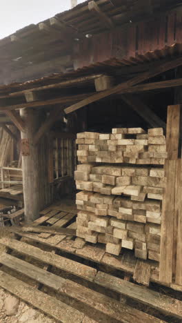 old wooden building with stacked lumber