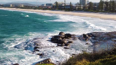 water runs back to the ocean from rocky shore after wave crashed on rocks. ultra slow motion shot. australia, wollongong.