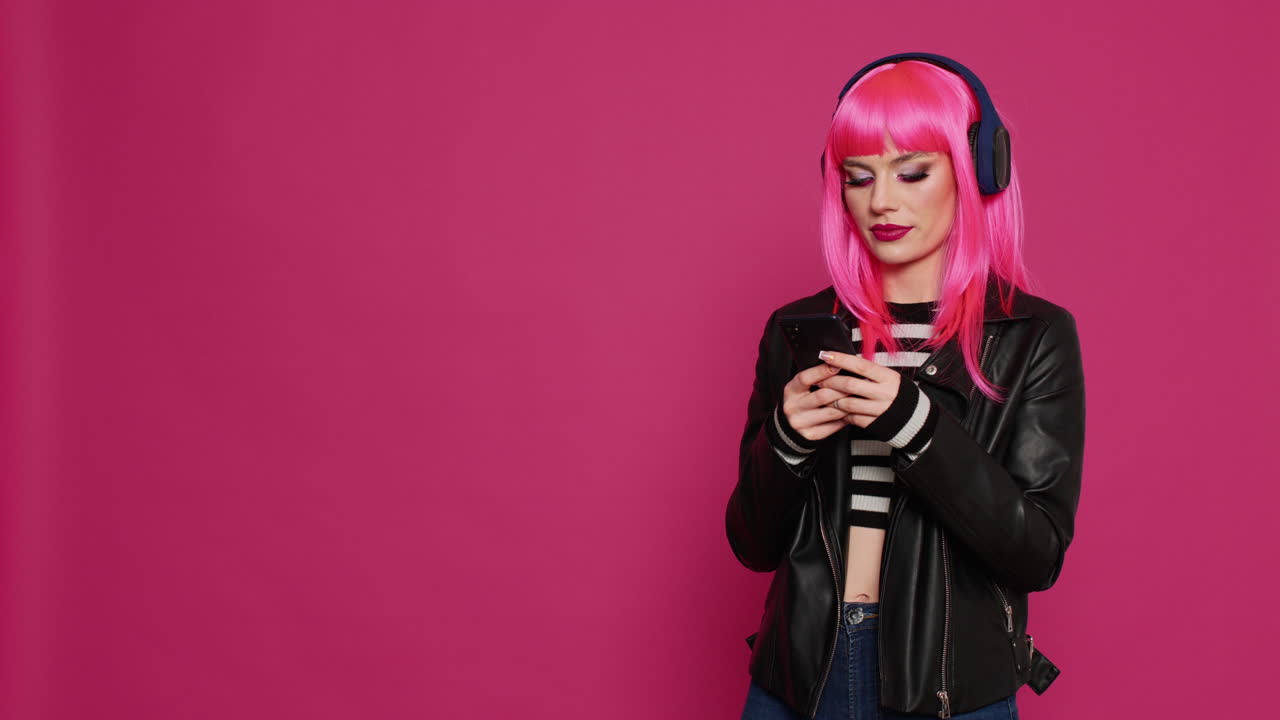 Cheerful confident adult with pink hair texting messages