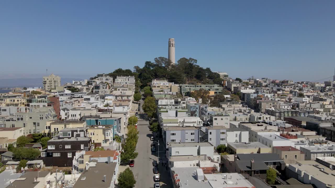 Smooth drone push-in of San Francisco's Coit Tower, gradually panning to reveal stunning downtown skyline