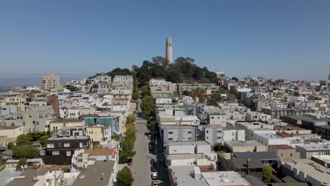 smooth drone push-in of san francisco's coit tower, gradually panning to reveal stunning downtown skyline