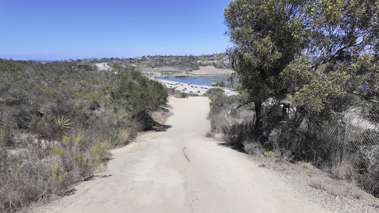 Visitors explore the winding sandstone passages of Annie’s Canyon Trail near Solana Beach. The shot reveals the contrast between shaded canyon walls and open blue sky near San Diego, California