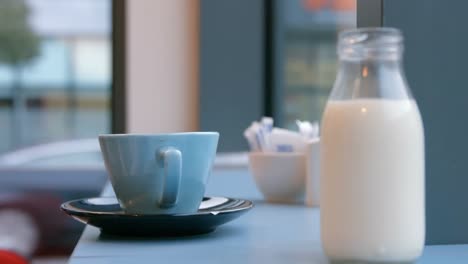 milk jug and cup on cafe table