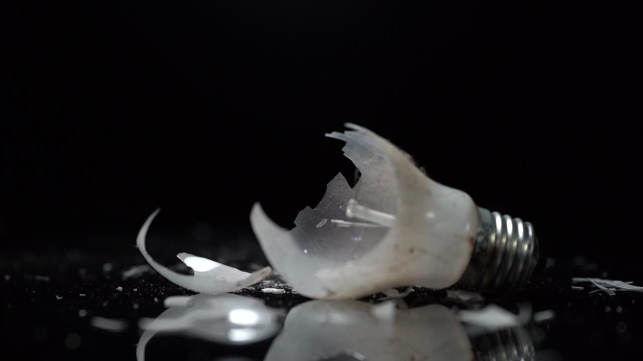 Glass pieces of broken bulb of incandescent lamp with tungsten wire, energy efficient concept