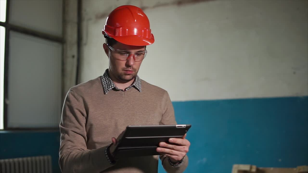 Engineer using tablet in industrial setting