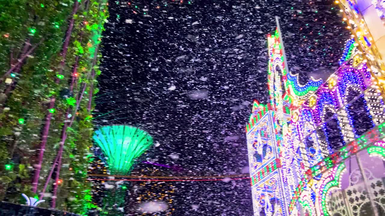 Artificial Foam Snow Falling During The Christmas Winter Wonderland Event With Supertree Groves At Gardens By The Bay In Singapore At Night.  -low angle shot