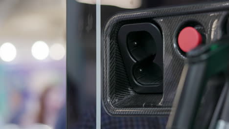 close-up of hand plugging in electric vehicle charger