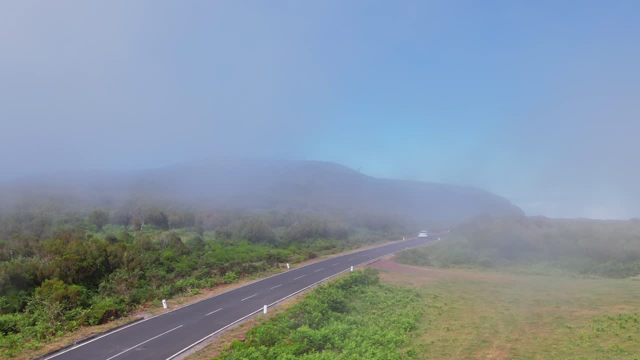 Scenic view of road winding through fog in Madeira, Portugal