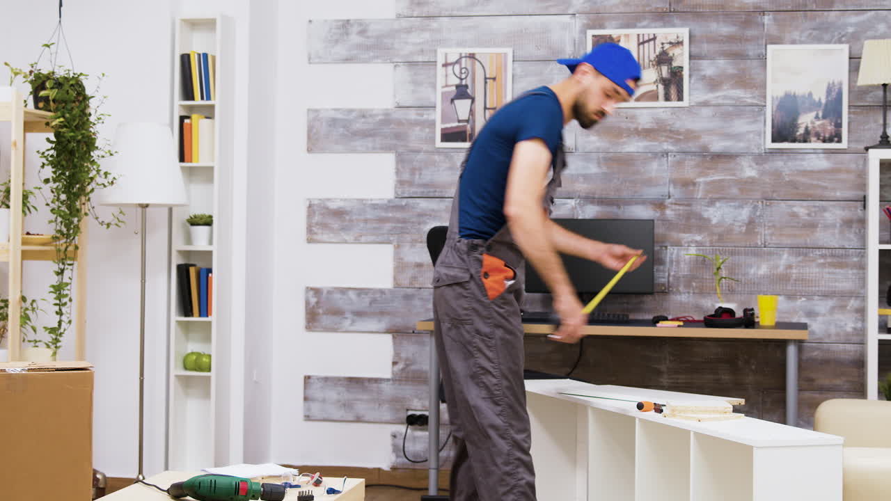 Handyman assembling furniture in a living room