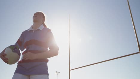 young adult female rugby player on a rugby pitch