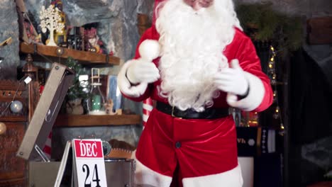 santa with white beard in red costume indoors. santa claus singing merrily on the 24th of december in his residence