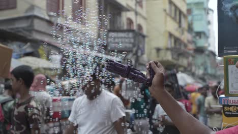 bubble gun on a busy south asian street