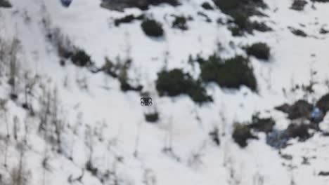 DJI-Avata-Drone-Flying-Outdoor-Against-Snowy-Mountain