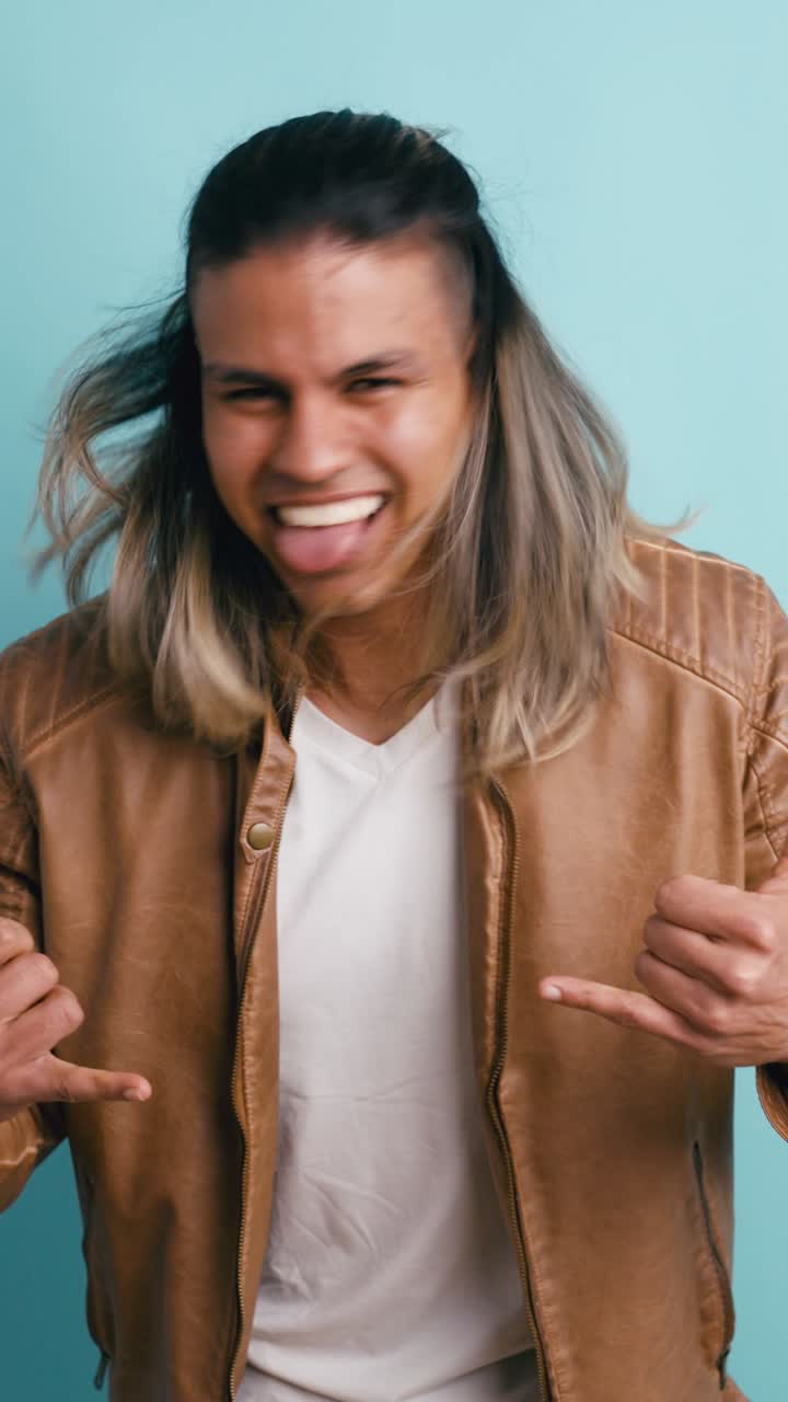 Playful Young Man Making Funny Face and Shaka Sign