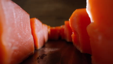 Motion-along-rows-of-cool-smoked-salmon-cubes-on-table