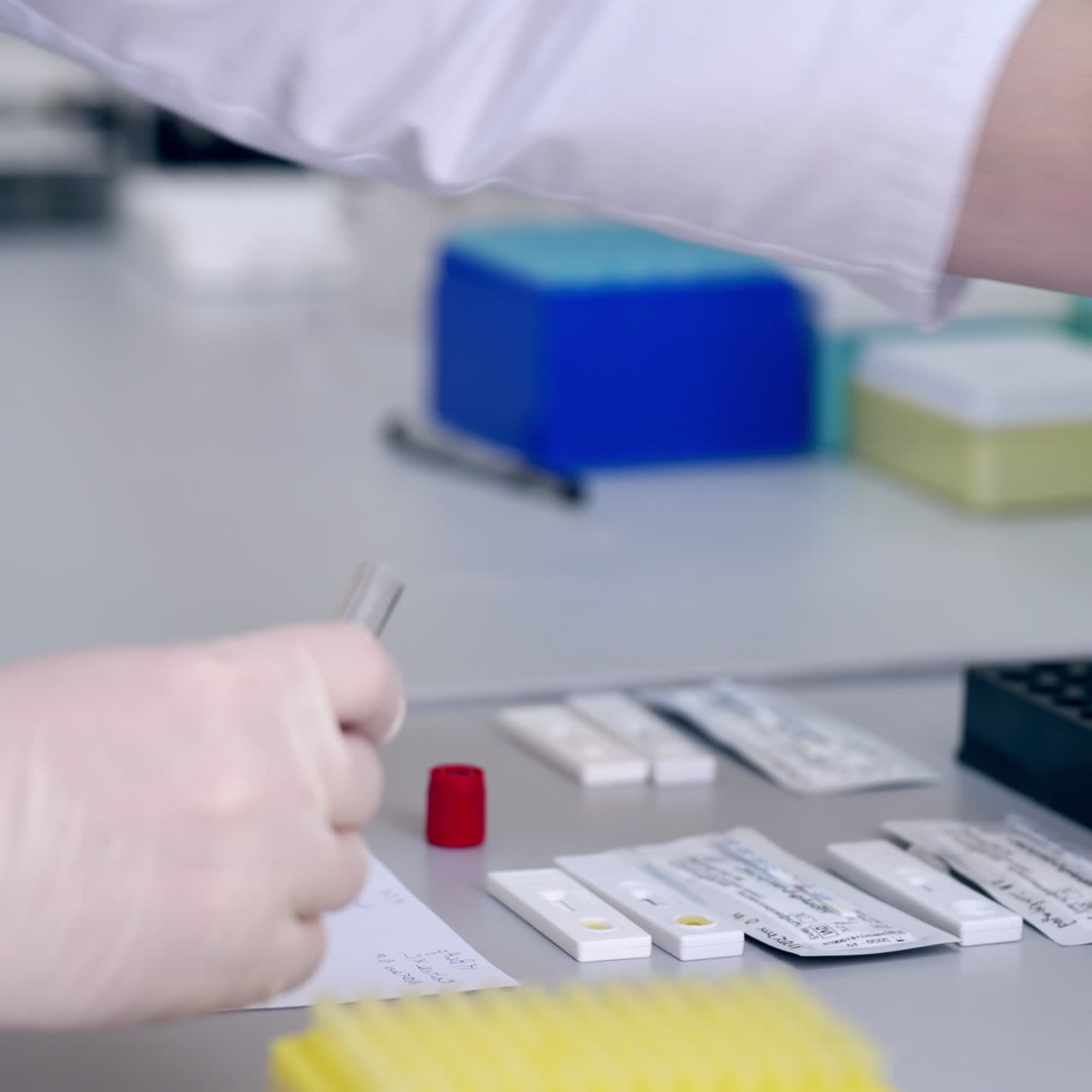 Medical assistant works with samples. Hands of medical worker in sterile gloves uses pipette during test analysis in the laboratory.
