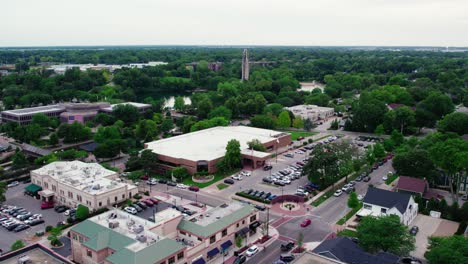 Phenomenal-aerial-Naperville-Illinois-above-Nichols-Library---Centennial-Beach-in-the-summer-and-Millennium-Carillon,-Rotary-Park-Sled-Hill,-Moser-Tower,-Naperville-Riverwalk-in-DuPage-County