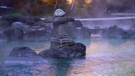 slow rising steam from natural hot spring water in kusatsu onsen, japan