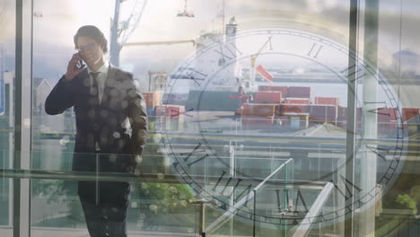 businessman talking on phone over clock animation and shipping port background