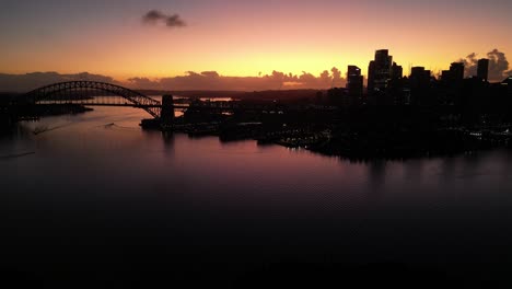 orange sky at sydney's harbour on a clear summer morning