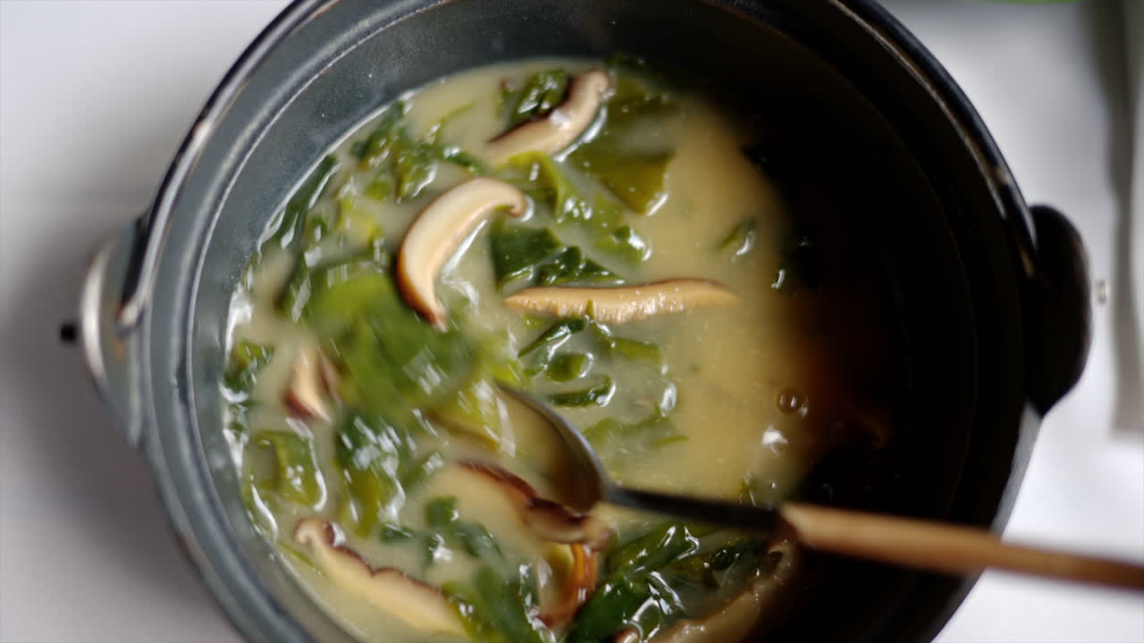 Japanese seaweed miso soup with tofu cheese, slow motion stir