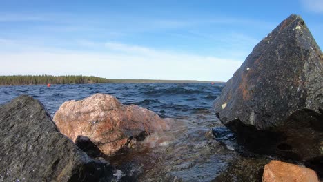 Beautiful-lake-scenery-with-waves-hitting-on-rocks-at-shore