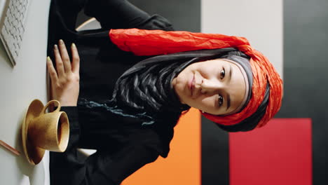 young muslim woman posing at desk vertical