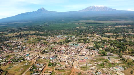 Aerial-drone-view-Open-Air-market-in-the-Loitokitok-town,-Kenya-and-mount-Kilimanjaro--Rural-village-of-Kenya