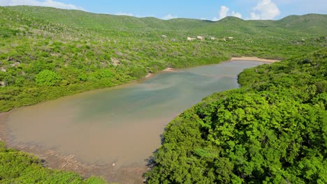 Historic-salt-pan-in-westpunt-behind-Grote-Knip-Curacao,-aerial-dolly