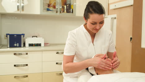 Facial-massage-seance-providing-by-female-cosmetician