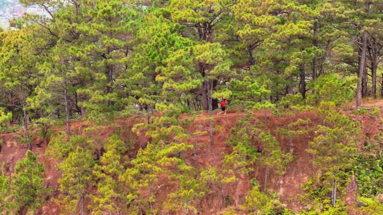 PERSON RUNNING UP MOUNTAIN DURING DAYTIME