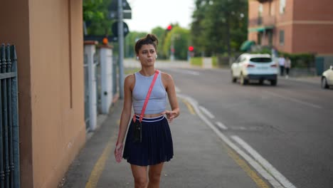 young woman walking down city street