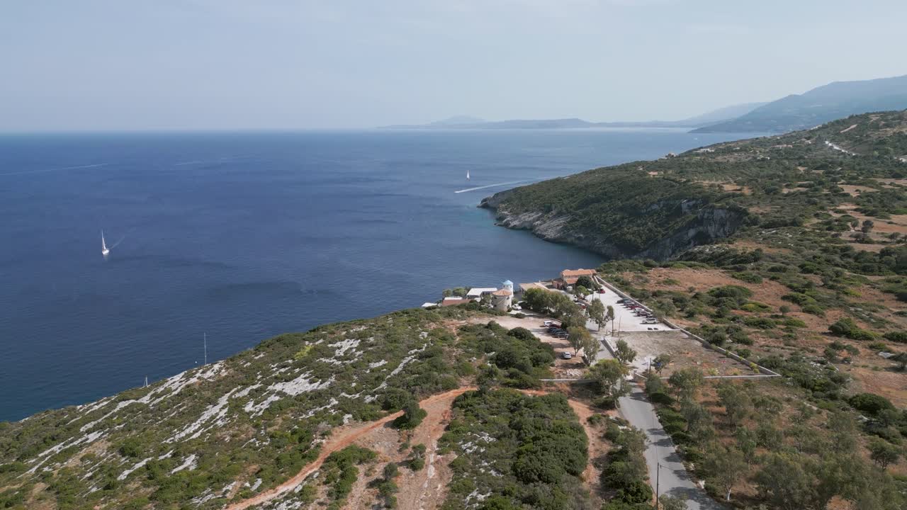 Serene coastal view from above with a sailboat on the horizon, Zante, Greece
