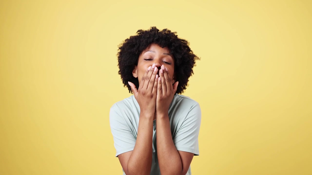Young African American Woman Blowing Air Kisses and Smiling