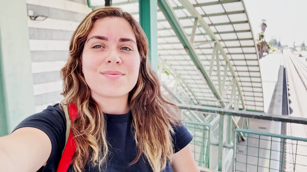 Happy Female Tourist Taking a Selfie on a City Bridge