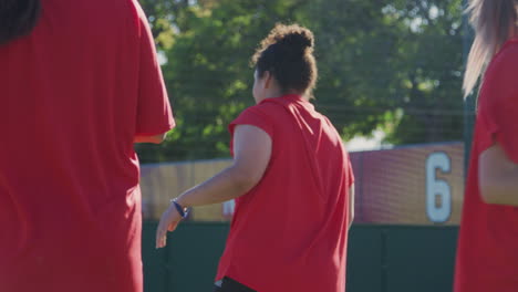 close up of female soccer team warming up during training before match