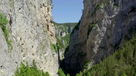 Drone-flying-through-the-natural-landmark-of-towering-marble-of-Trigrad-Gorge,-located-in-the-western-part-of-Rhodopes-Mountain-in-Bulgaria