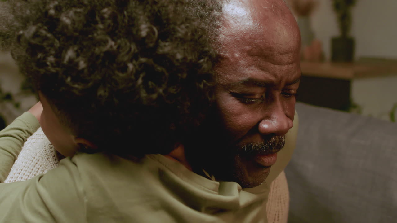 Old black man and boy talking at home