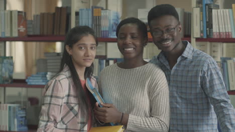 positive multicultural group thumb up in a library