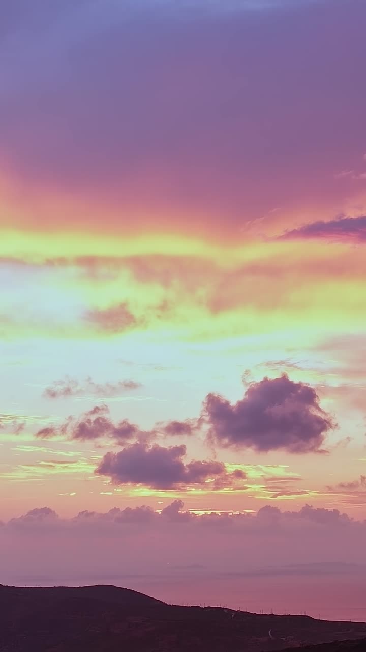 Vibrant Sunset Sky with Colorful Clouds Over Mountains and Ocean