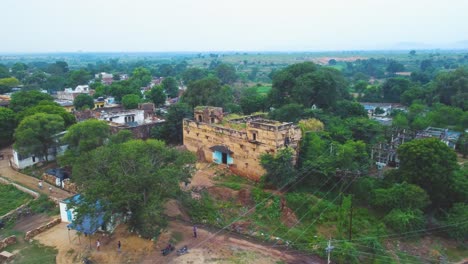 aerial drone shot of a old abandoned building or haveli in a rural village of gwalior , india