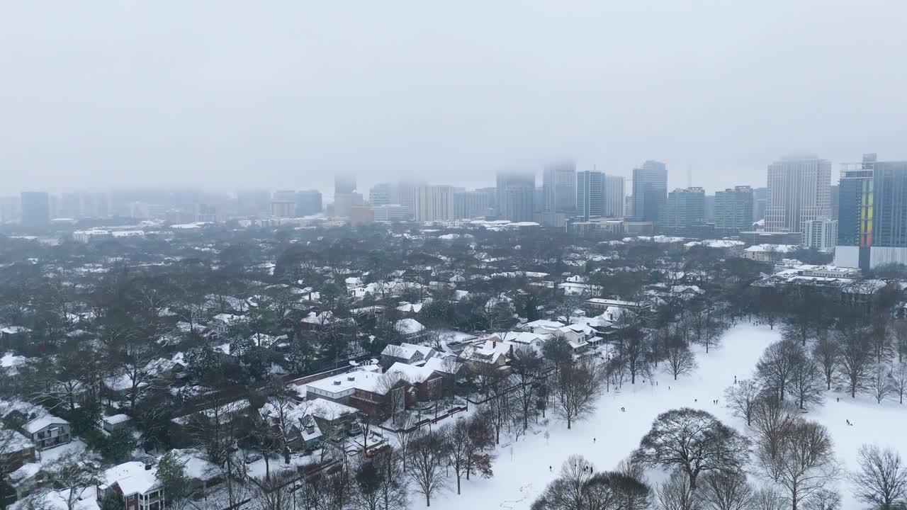Aerial shot of snow covered Atlanta suburbs with Midtown in the background.