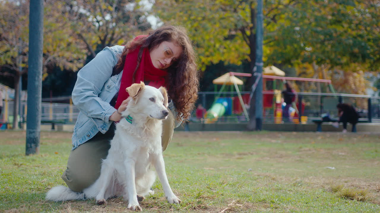 Careful Woman Petting Cute Dog in the Park
