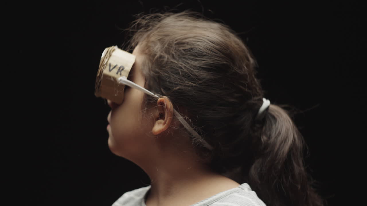 Close-up of Child Wearing Cardboard VR Headset and Pretending to Experience Virtual World