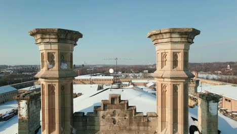 aerial of old juliet prison, flying between two pilons looking like a casttle