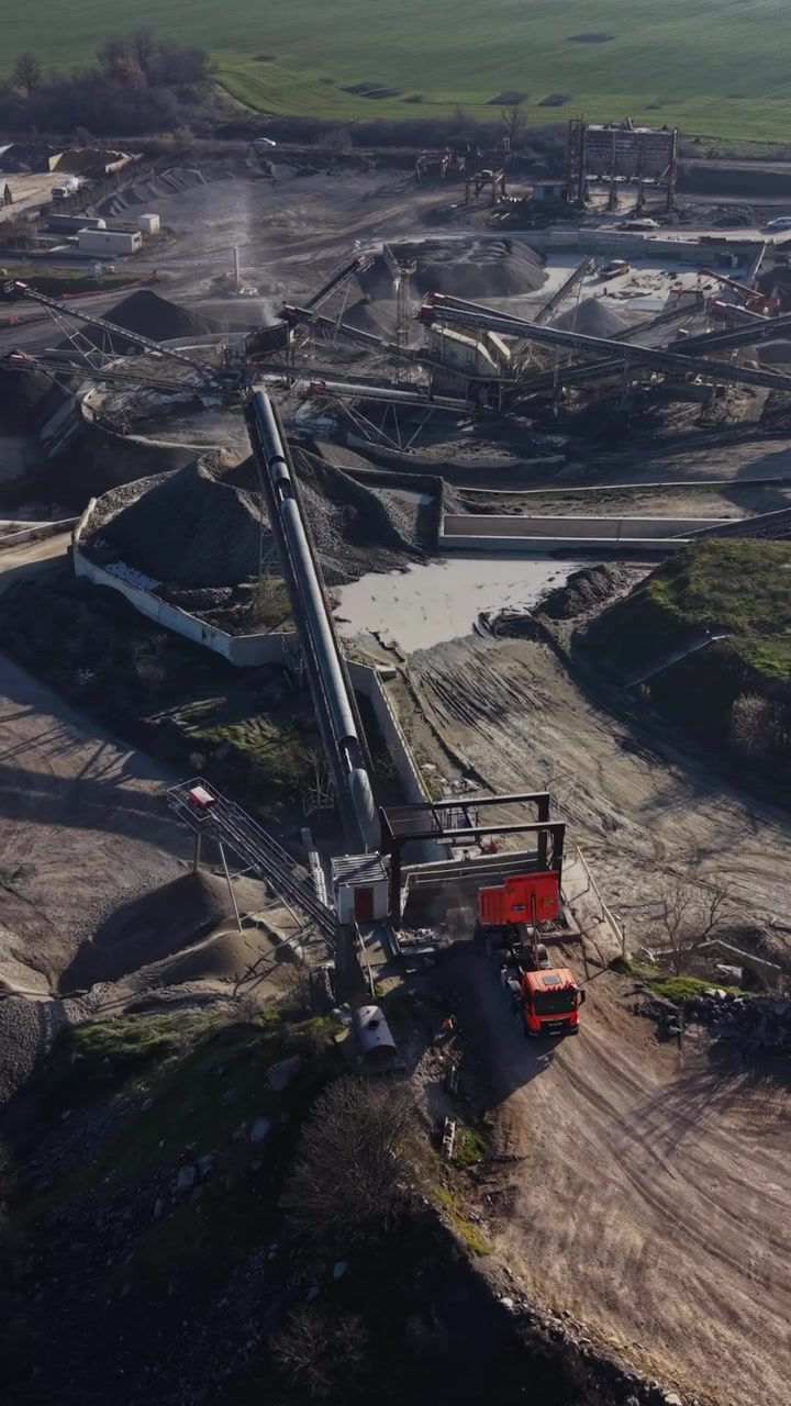 Mining operations at quarry site with equipment and vehicles