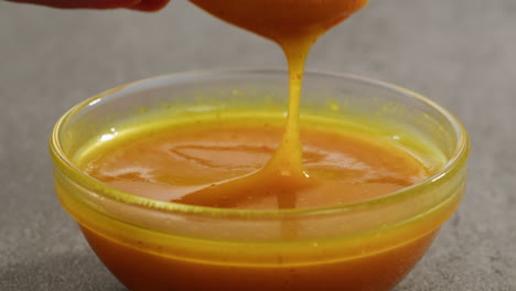 dipping a chicken nuggets in mustard sauce