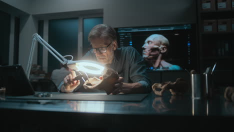 paleontologist examining fossil skull in laboratory